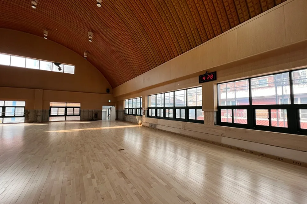 학교 체육관 아치형 목조 천장과 벽면 대형 통유리창 시공 현장